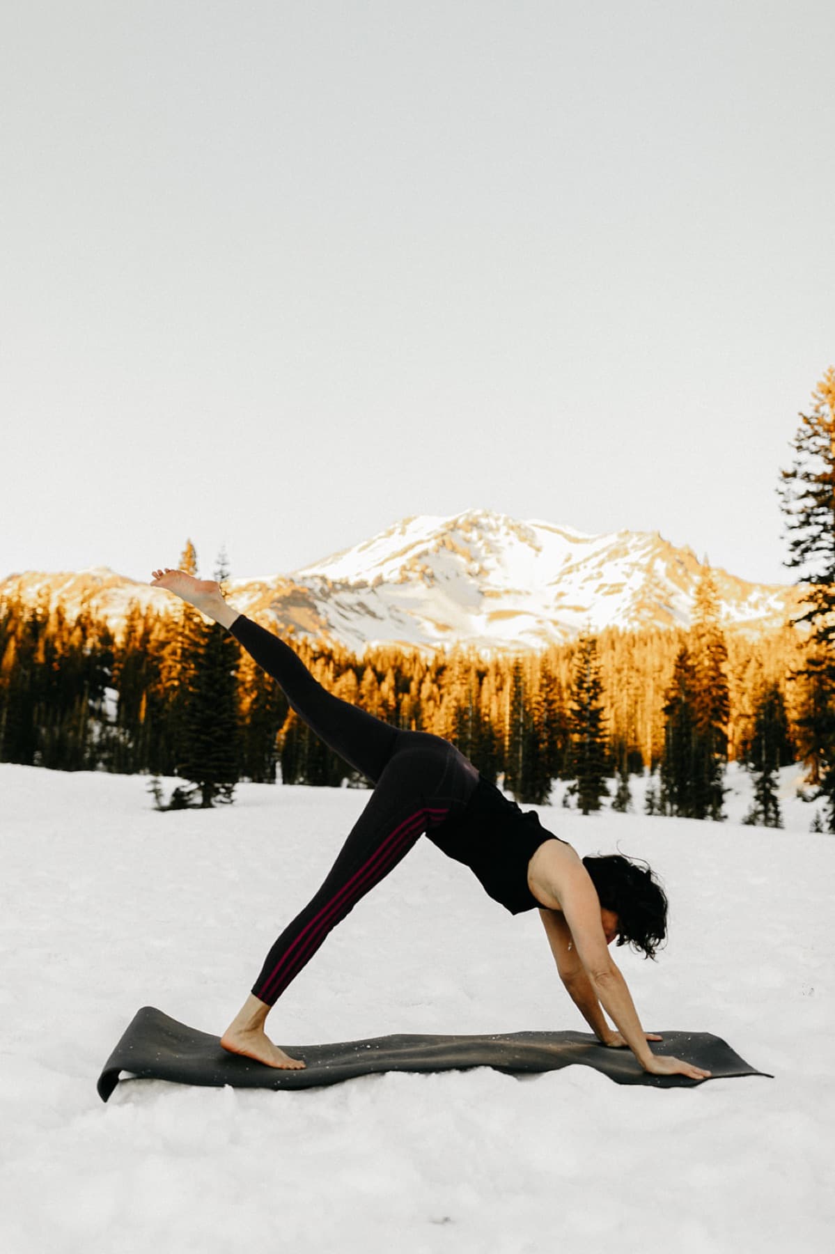 Heather Moyer in downward dog at Bunny Flat below Mt. Shasta