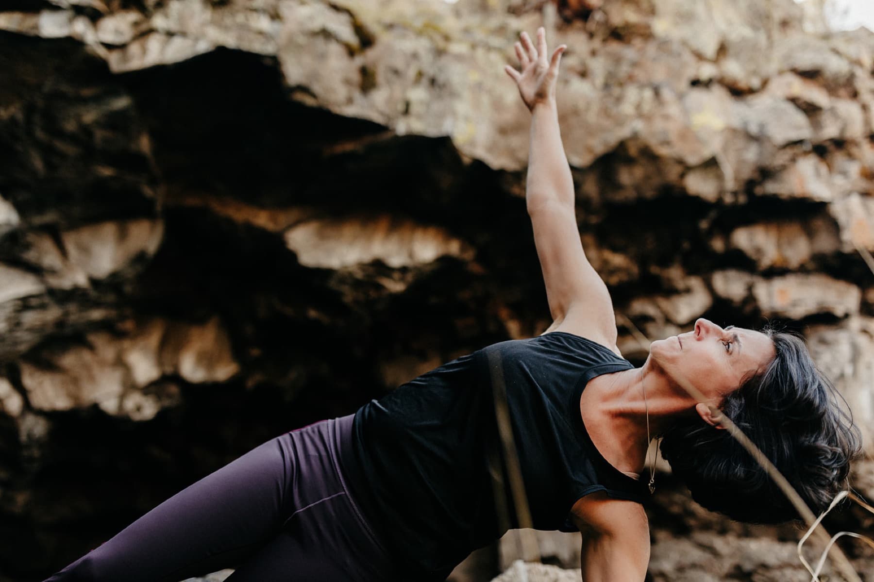 Heather Moyer in a side plank at Pluto Cave